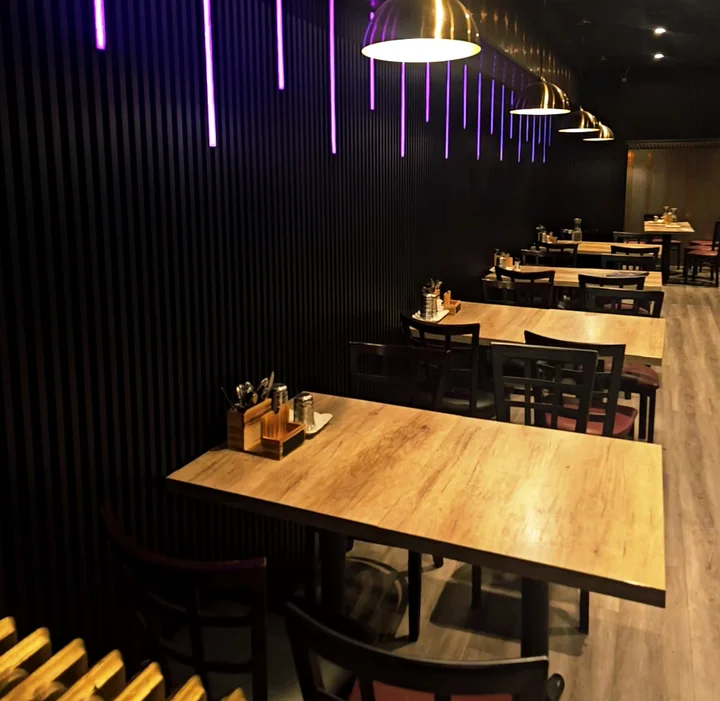 Dining room with wooden tables and pendant lights